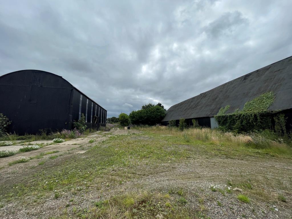 Lot: 158 - REDEVELOPMENT OPPORTUNITY - PLANNING CONSENT FOR TWO NEW BUILD DWELLINGS AND SEVEN BARN CONVERSIONS - View of site showing pair of barns